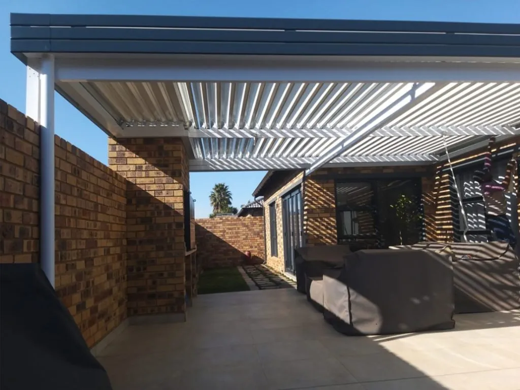 White adjustable louvre awning shading a residential patio