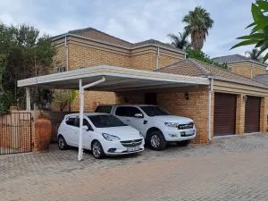 Double aluminium carport installed over a driveway
