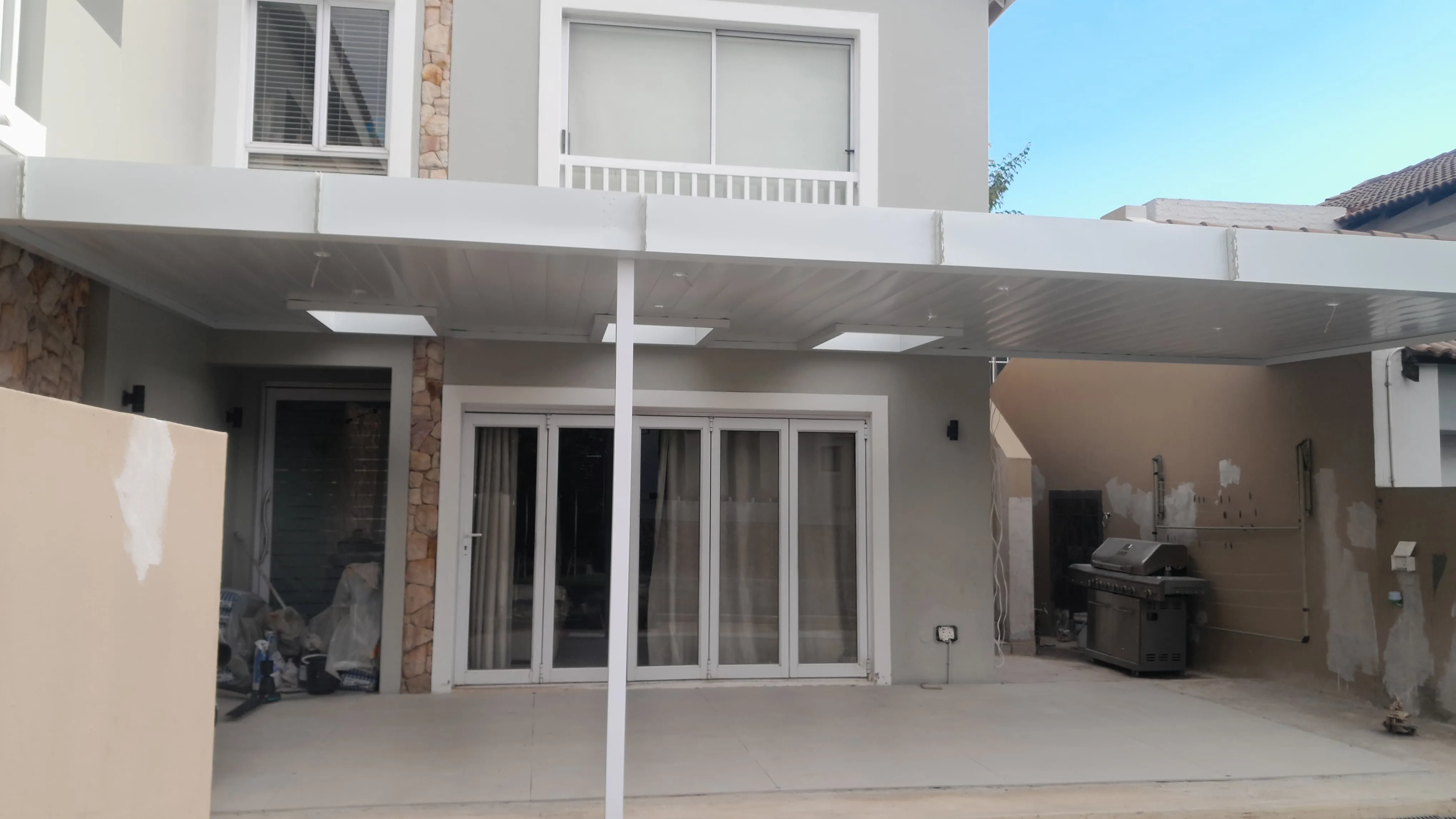 White patio ceiling roof with integrated skylight panels