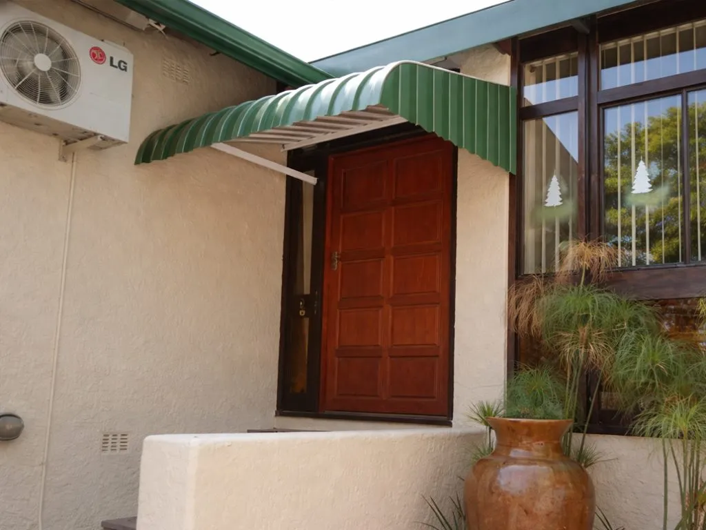 Fixed aluminium awning installed above a front door