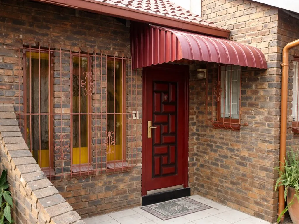 Curved awning installed above a residential entrance