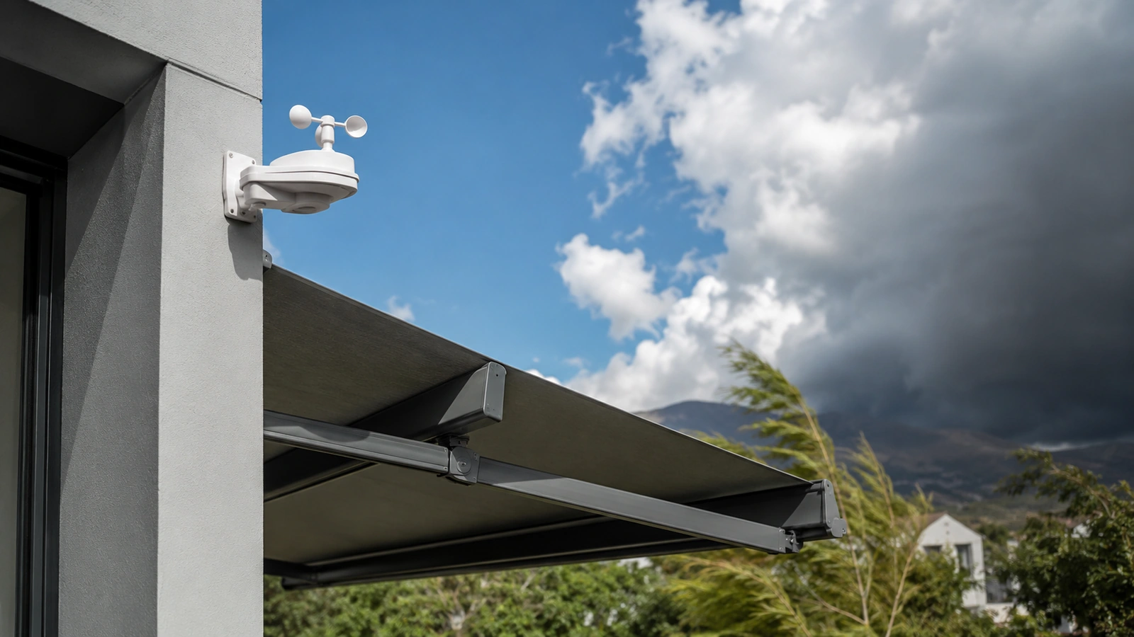 Wind and sun sensor unit mounted on the outer edge of an awning frame