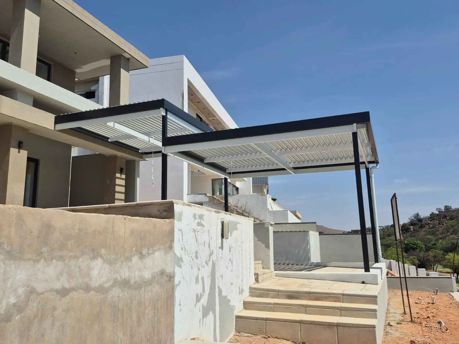 Charcoal and white louvre awnings installed at a modern home