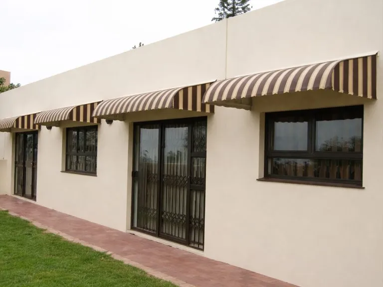 Fixed aluminium window awning above a home entrance for weather protection