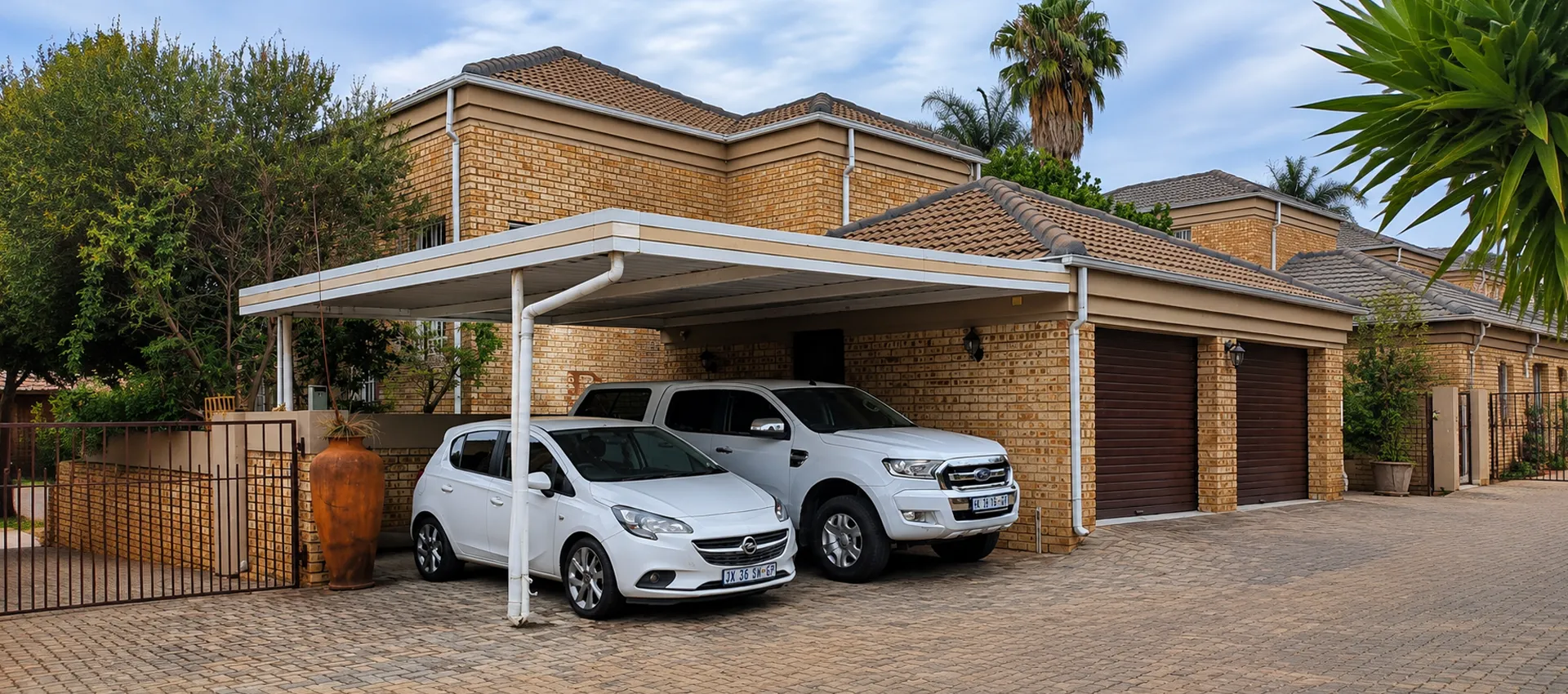Large custom carport protecting two vehicles at a Johannesburg home